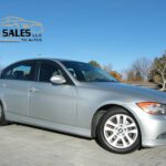 Silver BMW 3 Series parked on paved plaza