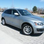 Silver SUV parked on brick driveway