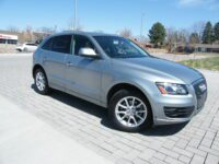 Silver SUV parked on brick driveway