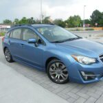 Front three-quarter view of blue Subaru hatchback