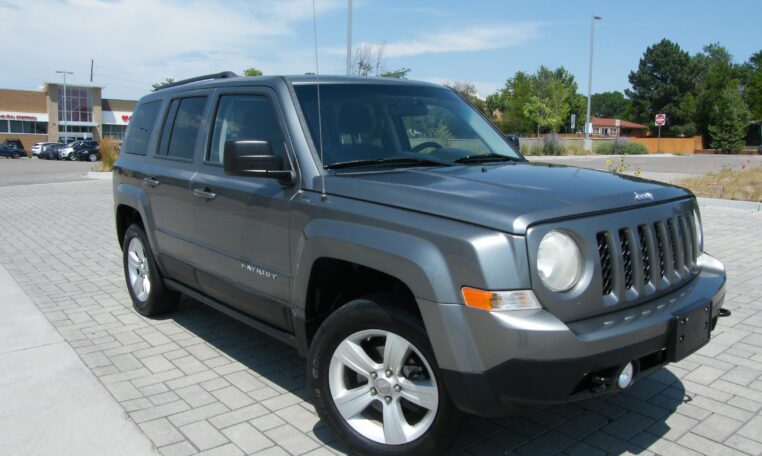 Gray compact SUV parked on brick driveway