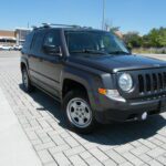 Dark gray SUV with roof rack parked