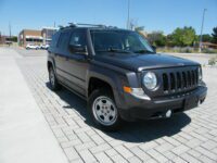 Dark gray SUV with roof rack parked